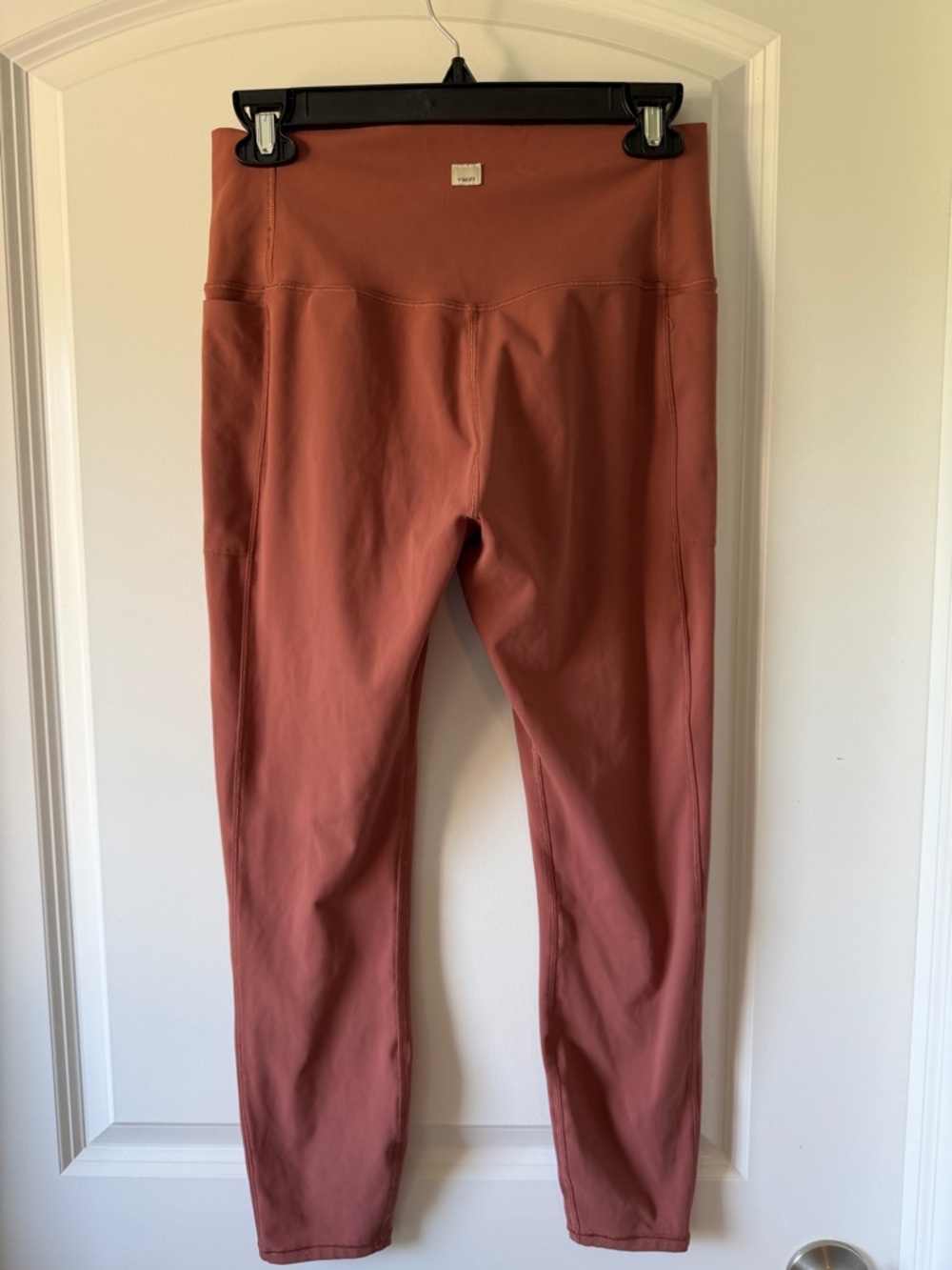 Vuori High-Rise Capri Yoga Leggings in Terra Cotta with pockets